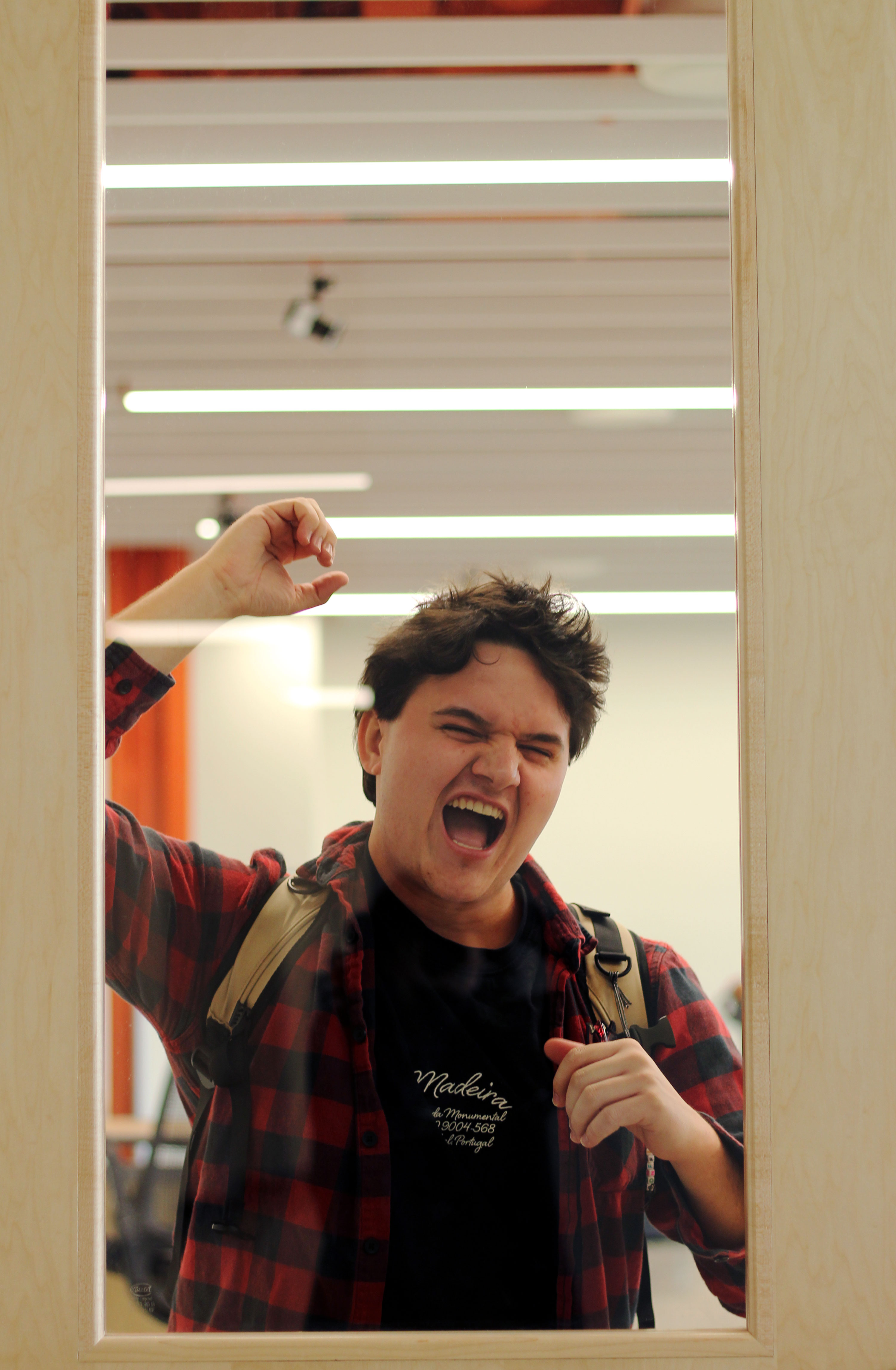 A man posing through a glass door window